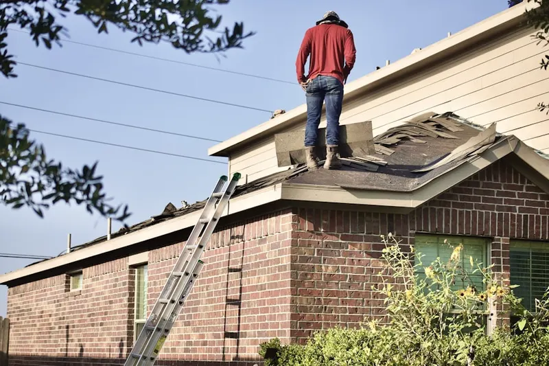 Professional roofer working on a residential roof in Tehrangeles